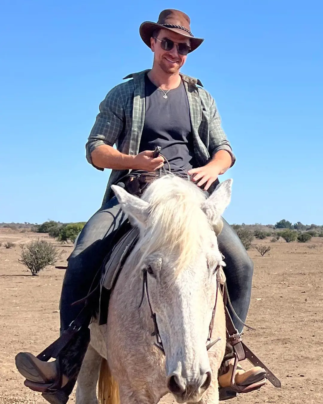 Richard enjoying his free time riding a horse