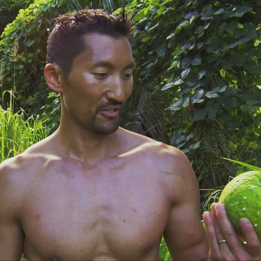 Kwon holding a breadfruit at the sets of Survivor