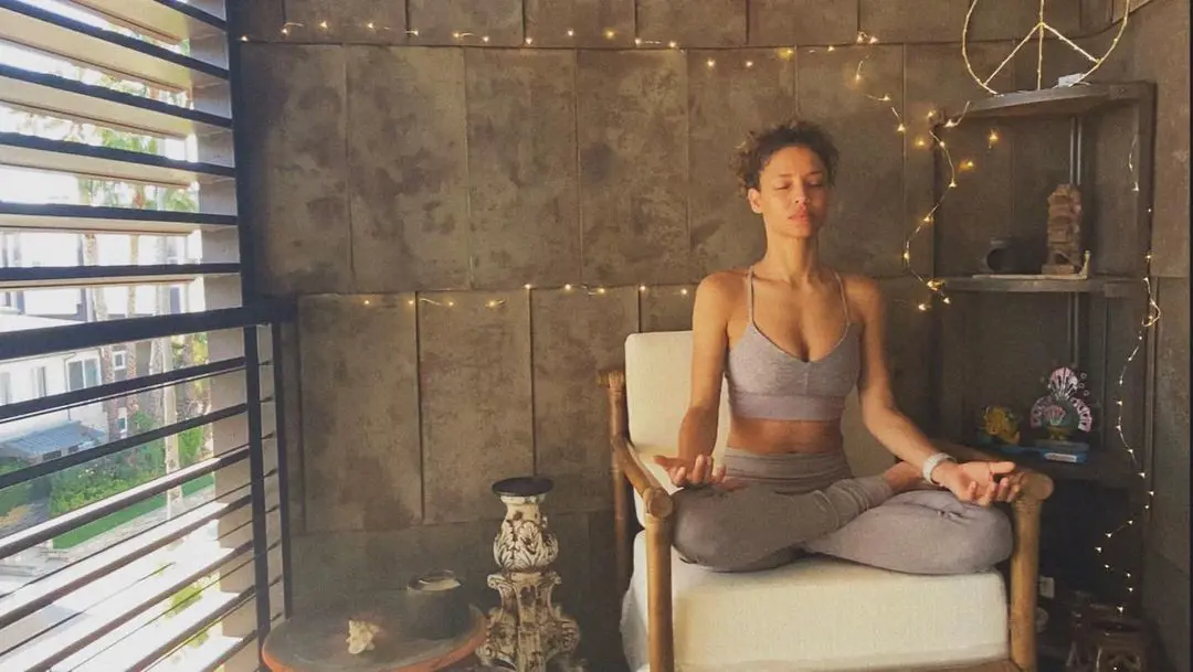 Brytni Sarpy meditating in her shared condo with Bryton James